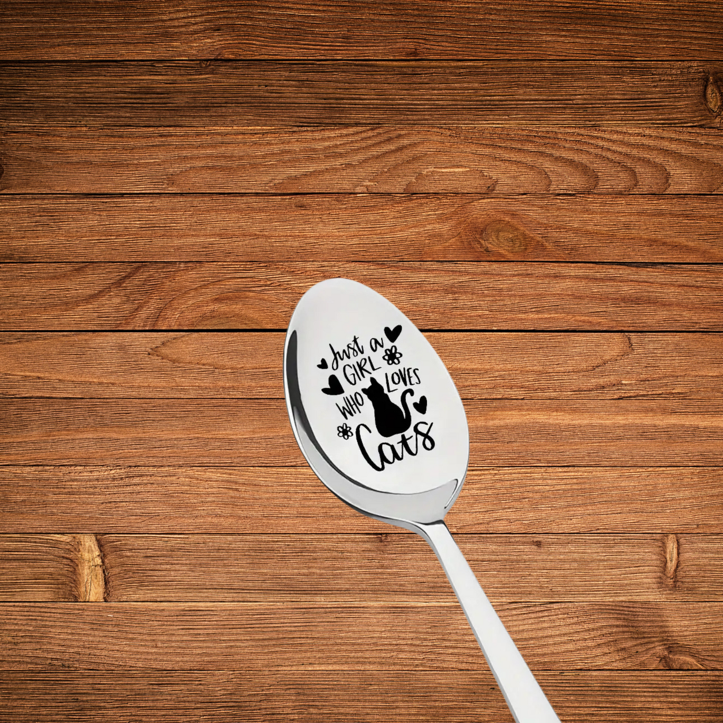 Stainless steel engraved spoon for tea/coffee. quote 2justa girl who loves cats" with a picture of a cat surrounded by hearts. Spoon is 19cm long.