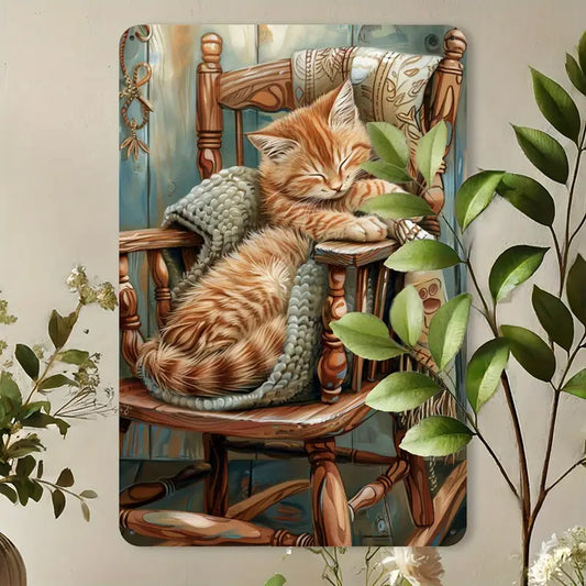 Vintage metal wall art showing a ginger kitten asleep in a blanket on a chair