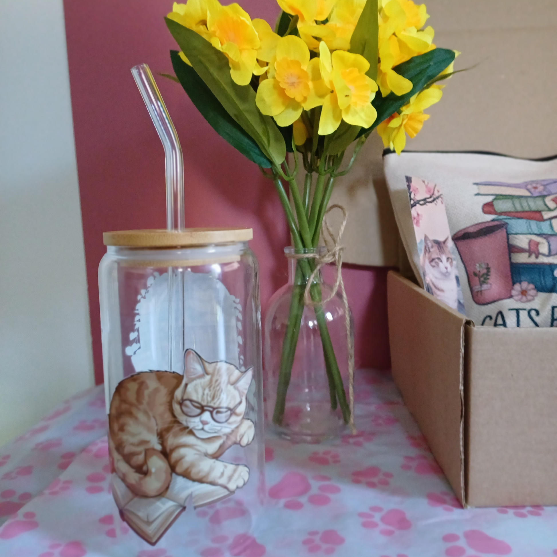 Back of glass tumbler showing a cat sleeping on a book with butterflies