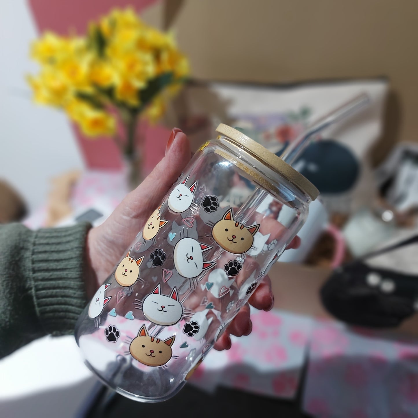 Cute glass with straw and bamboo lid featuring cat face designs and pastel hearts.