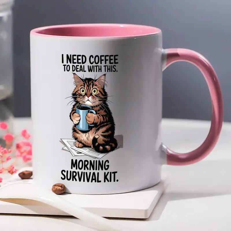 11oz funny cat mug. Comical cat holding a coffee cup with the quote "I need coffee to deal with this" Title of cup is "Morning survival kit.  White background with pink interior and handle.